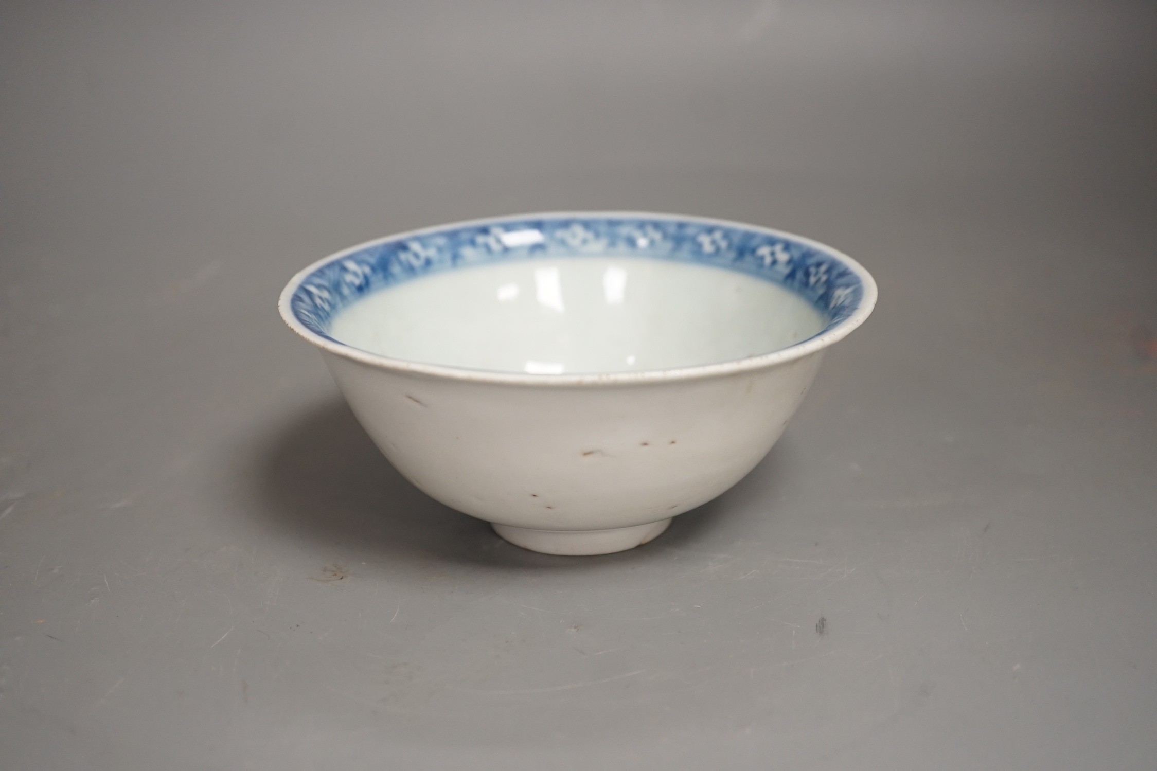 A Chinese late Ming blue and white lion-dog bowl, the base with ‘Made in the Great Ming dynasty’ mark, white exterior, 13cm diameter